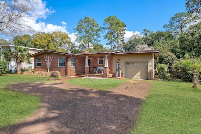 ranch-style house featuring a garage, a front yard, and covered porch