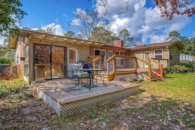 rear view of house featuring a wooden deck