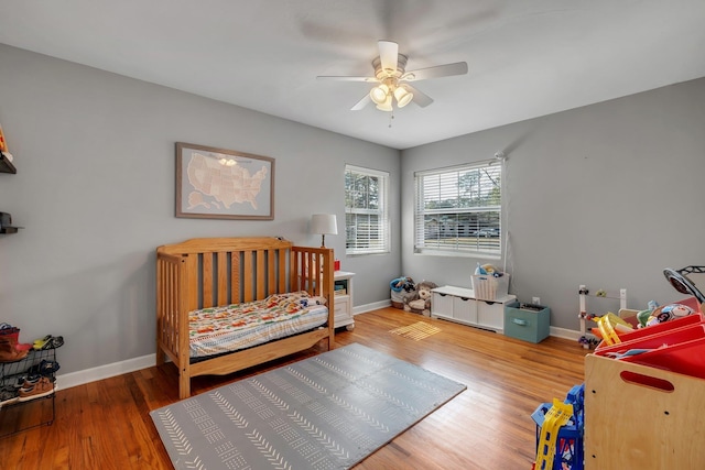 bedroom with hardwood / wood-style flooring and ceiling fan