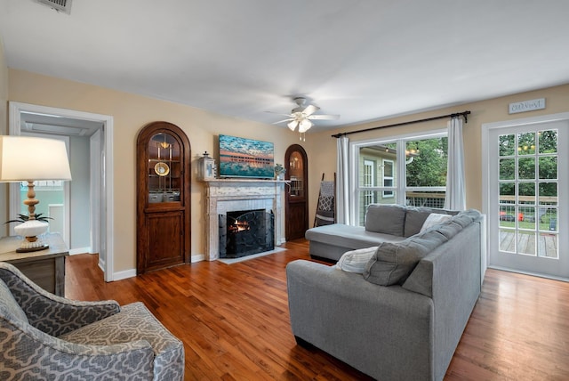 living room featuring dark hardwood / wood-style floors and ceiling fan