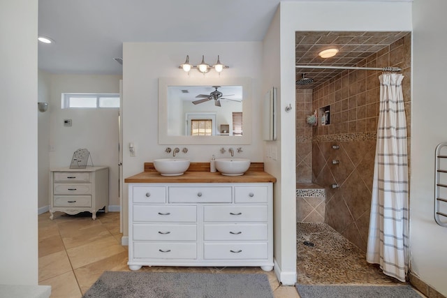 bathroom featuring tile patterned flooring, vanity, and curtained shower