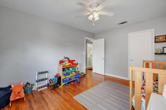 bedroom featuring hardwood / wood-style flooring and ceiling fan