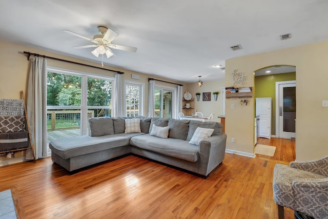 living room featuring light hardwood / wood-style flooring and ceiling fan