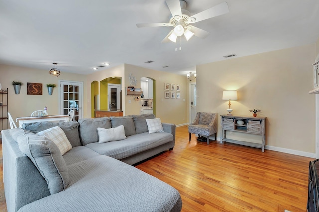 living room with ceiling fan and light hardwood / wood-style floors