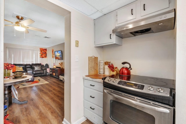 kitchen with ceiling fan, white cabinets, light hardwood / wood-style floors, and electric range