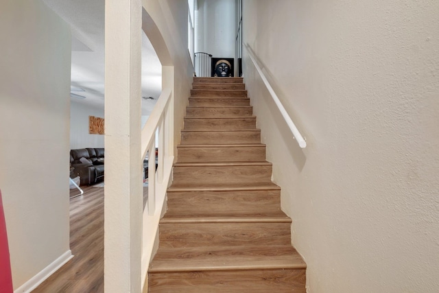 stairs featuring hardwood / wood-style floors