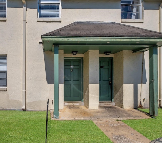 property entrance with a yard