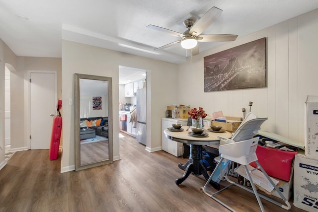 dining room featuring wood-type flooring and ceiling fan