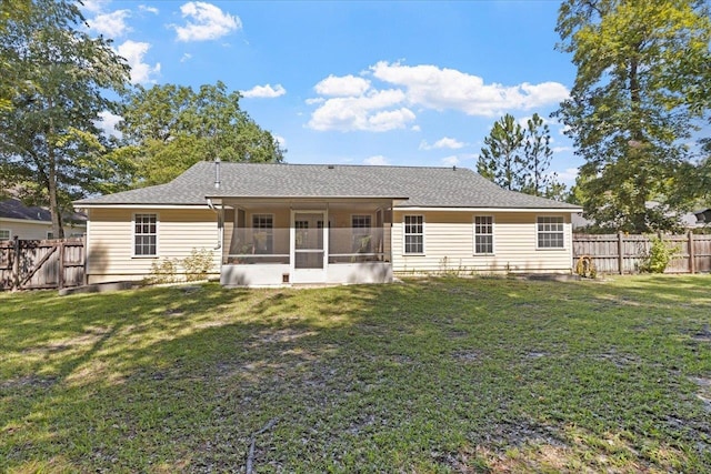 back of house with a lawn and a sunroom