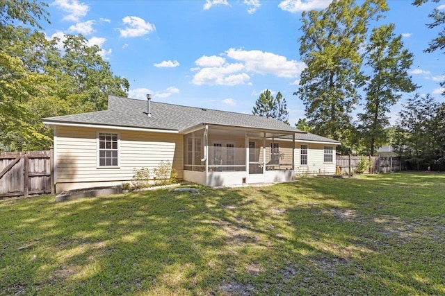 back of house with a sunroom and a lawn