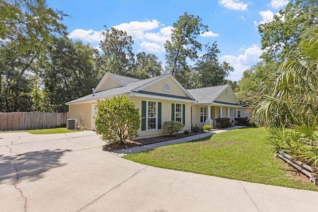 single story home with central air condition unit and a front lawn