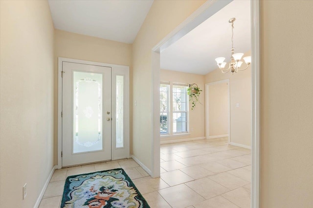 tiled foyer with an inviting chandelier and vaulted ceiling