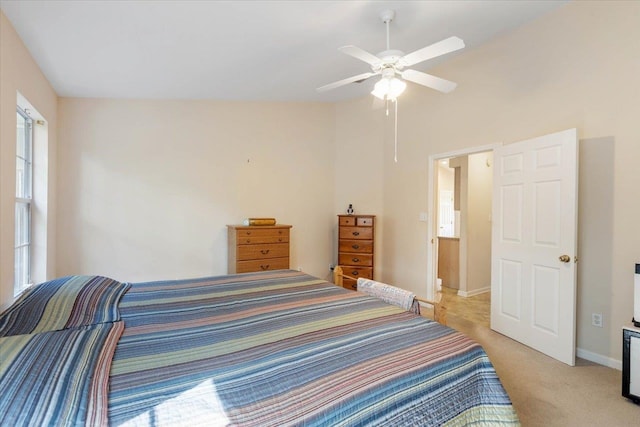 carpeted bedroom with vaulted ceiling and ceiling fan