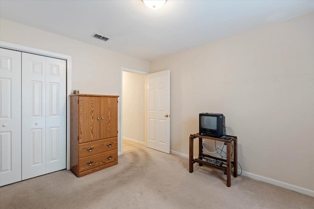 carpeted bedroom with a closet