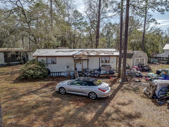 view of front of house featuring a storage shed