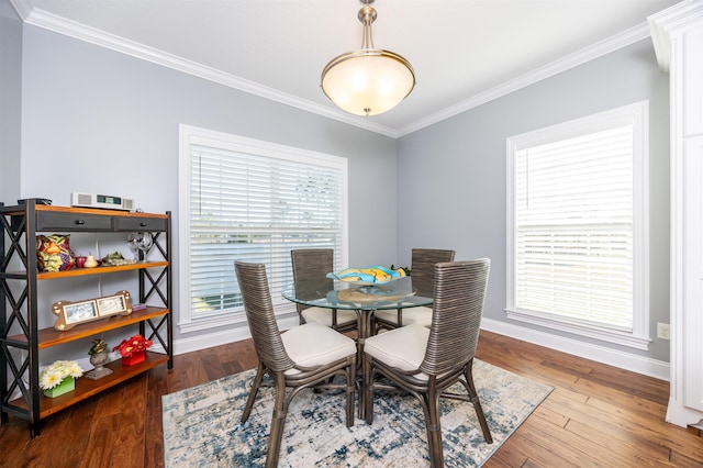 dining space featuring hardwood / wood-style floors and ornamental molding