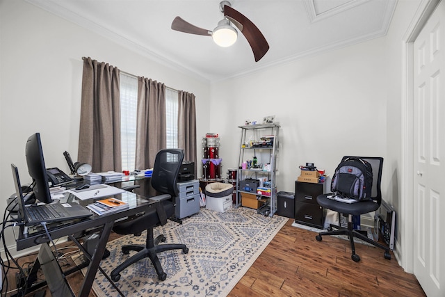 home office with ornamental molding, ceiling fan, and dark wood-type flooring