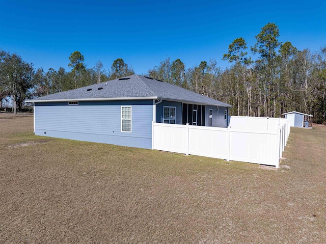 view of side of home with a yard