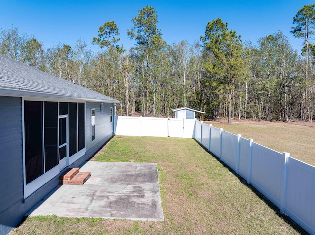 view of yard with a sunroom and a patio area