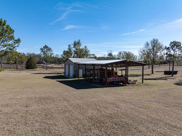 view of outdoor structure with a garage and a yard