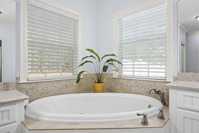 bathroom with vanity, tiled bath, and crown molding