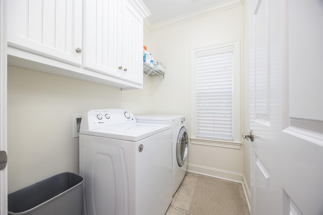 laundry room featuring cabinets, light tile patterned floors, ornamental molding, and washing machine and clothes dryer