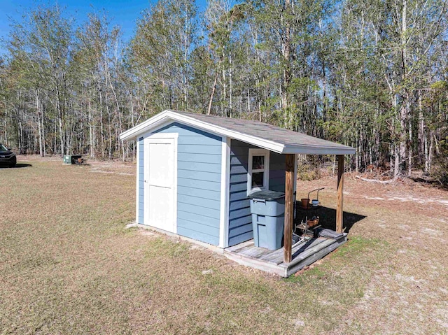 view of outbuilding featuring a lawn