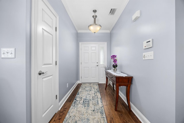 entrance foyer with dark hardwood / wood-style floors and crown molding