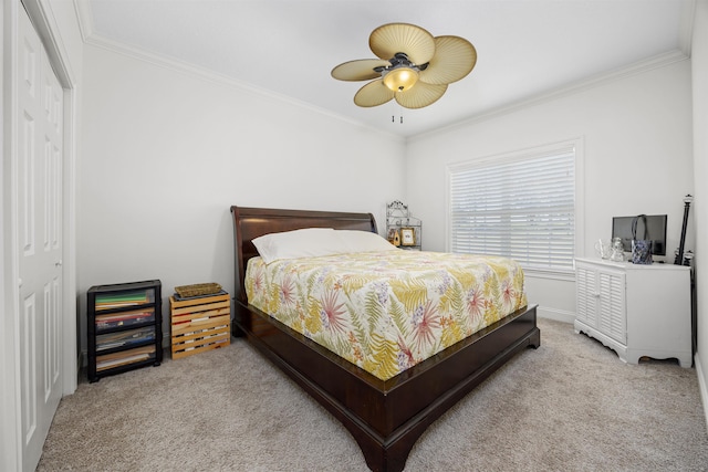 bedroom featuring ceiling fan, ornamental molding, light carpet, and a closet