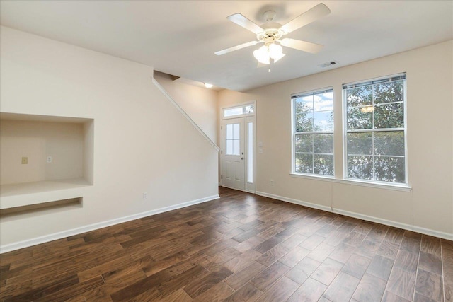 interior space featuring dark wood-type flooring and ceiling fan