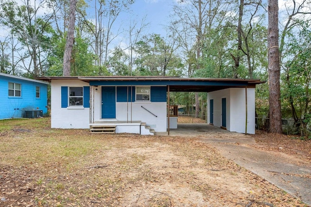 view of front of house with cooling unit and a carport