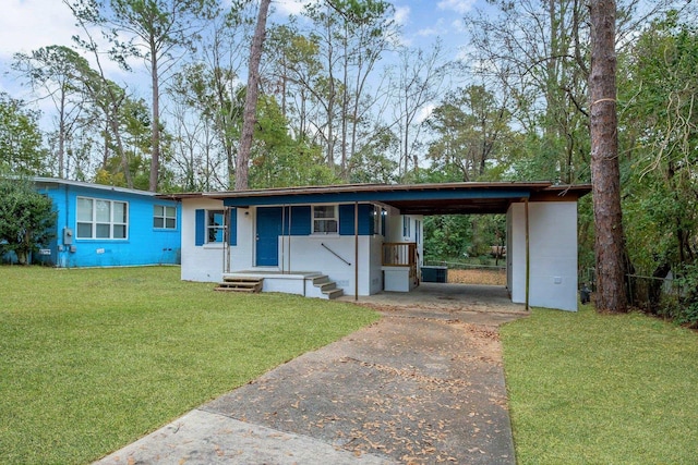 view of front of home with a carport, a front lawn, and central air condition unit