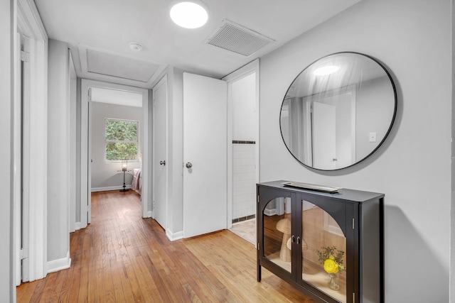 corridor with light hardwood / wood-style floors