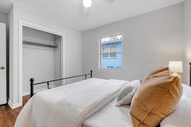 bedroom with dark wood-type flooring, a closet, and ceiling fan