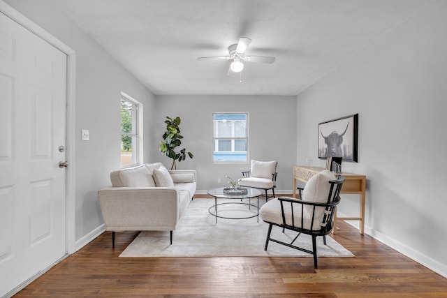 living room with ceiling fan, plenty of natural light, and dark hardwood / wood-style flooring