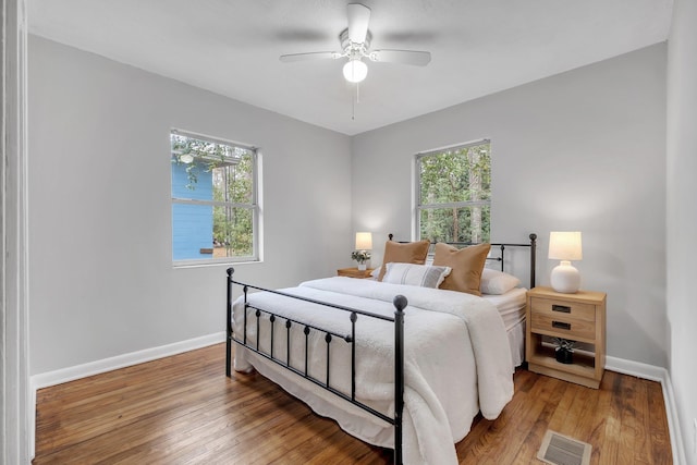 bedroom with hardwood / wood-style floors and ceiling fan