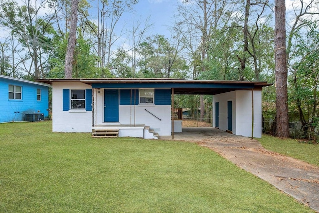 view of front of house with a front yard, a carport, and central air condition unit