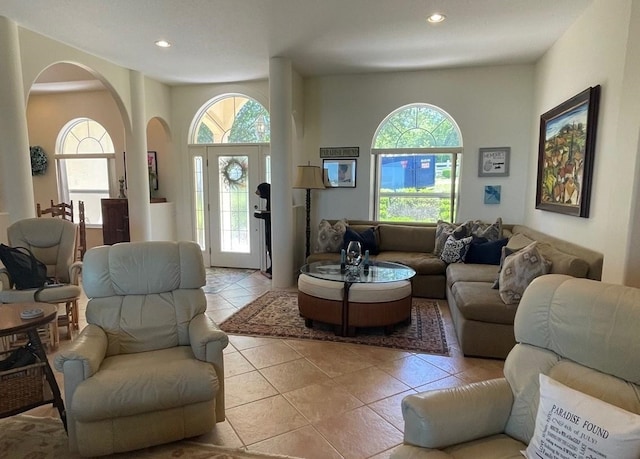 living room featuring light tile patterned flooring, arched walkways, and recessed lighting
