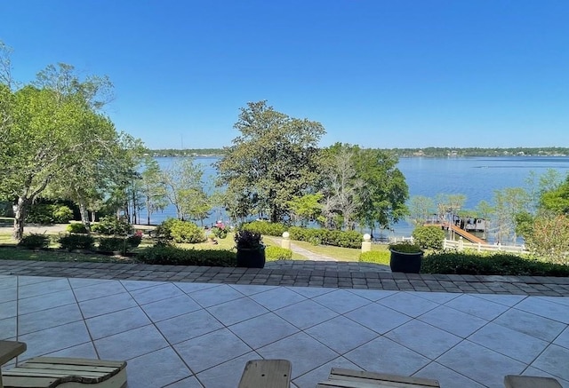 view of swimming pool featuring a patio area and a water view