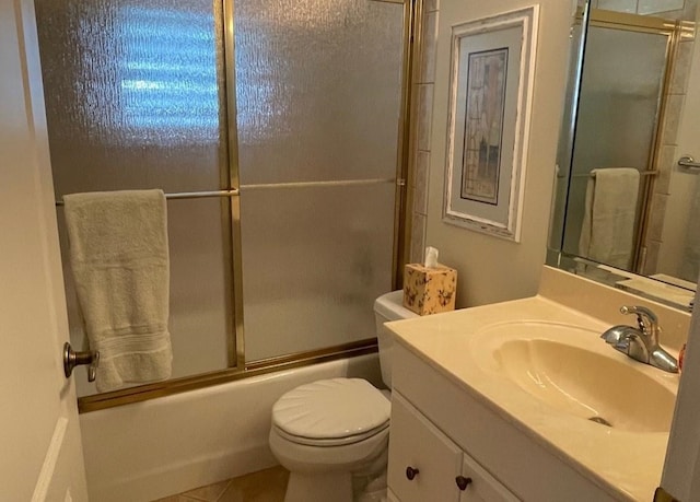 full bathroom featuring toilet, vanity, tile patterned floors, and shower / bath combination with glass door