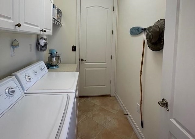 washroom featuring cabinet space, independent washer and dryer, and light tile patterned floors