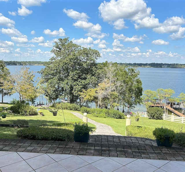 surrounding community with a yard and a water view