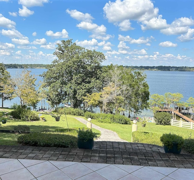 view of home's community featuring a water view and a lawn