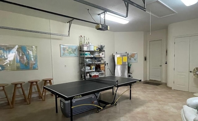 playroom featuring a garage and attic access