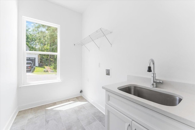 clothes washing area with cabinet space, washer hookup, baseboards, and hookup for an electric dryer