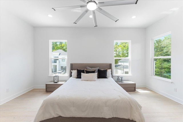 bedroom with light wood finished floors, recessed lighting, baseboards, and a ceiling fan