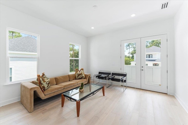 living room with light wood-style flooring, baseboards, french doors, and recessed lighting