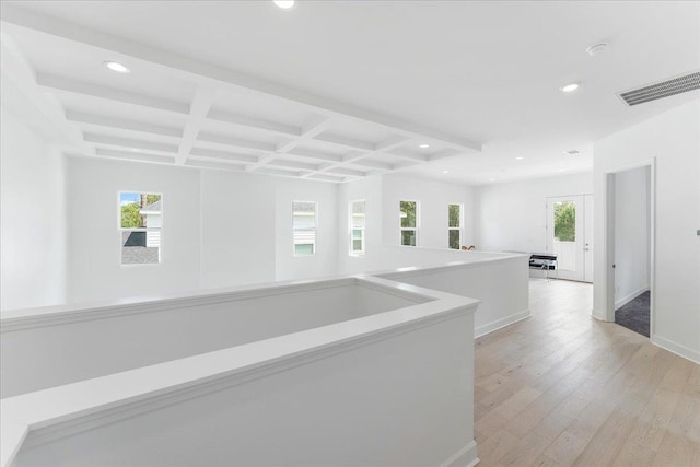 corridor featuring coffered ceiling, recessed lighting, healthy amount of natural light, light wood-style flooring, and beamed ceiling