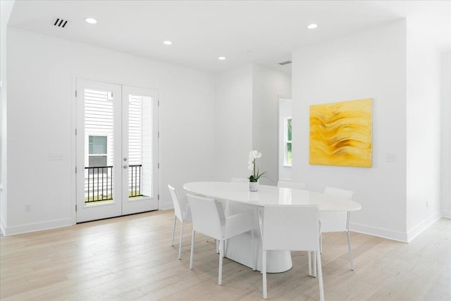 dining area with french doors, light wood-style floors, baseboards, and recessed lighting