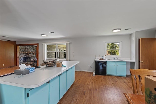 203 Forest Cir, Perry, FL 32347 - kitchen featuring blue cabinetry, dishwasher, light wood-style flooring, and light countertops
